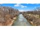 Aerial view of a clear river winding through a landscape of bare trees and shrubs at 207 E Ohio St, Mooresville, IN 46158