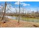 The property features waterfront access to a serene river, with mature trees lining the bank at 207 E Ohio St, Mooresville, IN 46158