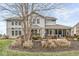 A spacious backyard with a screened-in porch, patio seating, grill, and lush landscaping at 209 North Bnd, Greenwood, IN 46142