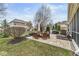 A spacious backyard with a patio, outdoor furniture, grill, lush landscaping, and sunny sky at 209 North Bnd, Greenwood, IN 46142
