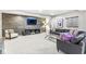 Finished basement boasting a stone accent wall, plush carpeting, and comfortable seating area for relaxing and entertaining at 209 North Bnd, Greenwood, IN 46142