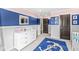 bedroom featuring a white dresser, an anchor rug and blue accent wall at 209 North Bnd, Greenwood, IN 46142