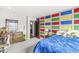 Brightly colored bedroom with decorative wall, wooden dresser, and a blue bed at 209 North Bnd, Greenwood, IN 46142