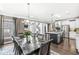 Open-concept dining area with views of the modern kitchen and staircase at 209 North Bnd, Greenwood, IN 46142
