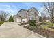 Two-story home featuring a wide driveway leading to a two car garage and beautifully landscaped yard at 209 North Bnd, Greenwood, IN 46142