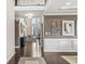 Grand foyer featuring high ceilings, dark hardwood flooring, decorative wall paneling and a view into the living room at 209 North Bnd, Greenwood, IN 46142