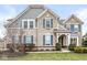 Charming two-story home featuring brick facade, blue shutters, manicured lawn, and professionally landscaped yard at 209 North Bnd, Greenwood, IN 46142