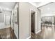 Bright hallway with hardwood floors that leads to a dining room and has doors on both sides at 209 North Bnd, Greenwood, IN 46142
