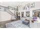 Open-concept living room with a staircase, large sofa, and lots of natural light at 209 North Bnd, Greenwood, IN 46142