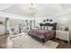 Inviting main bedroom with tray ceiling, sitting area, and decorative lighting at 209 North Bnd, Greenwood, IN 46142