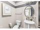 Stylish powder room featuring a pedestal sink, decorative mirror, and modern fixtures at 209 North Bnd, Greenwood, IN 46142