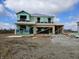New two story home under construction with visible framing and green weather barrier on a sunny day at 2242 Oakmont Dr, Plainfield, IN 46168