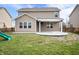 Spacious backyard features a covered patio, green grass, and established landscaping at 2324 Boneset Dr, Plainfield, IN 46168