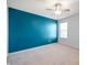 Nicely carpeted bedroom with a vibrant accent wall, ceiling fan, and a bright window at 2324 Boneset Dr, Plainfield, IN 46168