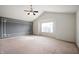 Spacious bedroom features a unique accent wall, a large window, and a ceiling fan at 2324 Boneset Dr, Plainfield, IN 46168