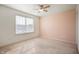 Bright bedroom with a large window, a ceiling fan, and neutral carpeting at 2324 Boneset Dr, Plainfield, IN 46168
