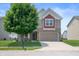 Charming two-story home featuring a well-manicured lawn and attached two-car garage at 2324 Boneset Dr, Plainfield, IN 46168