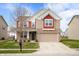 Charming two-story home with a brick and siding exterior, attached garage, and well-maintained lawn at 2324 Boneset Dr, Plainfield, IN 46168