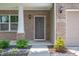 Charming home entryway featuring a welcome mat, brick facade, and attractive landscaping at 2324 Boneset Dr, Plainfield, IN 46168
