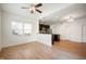 Well-lit living space with hardwood floors, dark cabinets, and a view of the backyard at 2324 Boneset Dr, Plainfield, IN 46168
