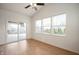 Bright sun room with hardwood floors, a ceiling fan, and sliding door access to the backyard at 2324 Boneset Dr, Plainfield, IN 46168