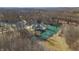 Idyllic aerial view of a stone home surrounded by tranquil water and mature trees in a peaceful, secluded setting at 2437 W Wavelyn N Cir, Martinsville, IN 46151
