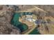 Aerial view of a brick home surrounded by a pond and bare trees at 2437 W Wavelyn N Cir, Martinsville, IN 46151