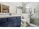Modern bathroom features a beautiful tiled shower, stylish vanity with sink, and updated fixtures at 2437 W Wavelyn N Cir, Martinsville, IN 46151