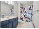 Bathroom with blue vanity and colorful shower curtain at 2437 W Wavelyn N Cir, Martinsville, IN 46151