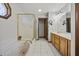 Bright bathroom with a luxurious soaking tub, separate shower, and double vanity with wooden cabinets at 2437 W Wavelyn N Cir, Martinsville, IN 46151
