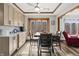 Sunny dining area with modern wood floors, trim, ceiling fan, and natural light streaming in from a large picture window at 2437 W Wavelyn N Cir, Martinsville, IN 46151