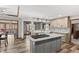 Bright kitchen with granite countertops, tile backsplash, an island cooktop, and modern stainless steel appliances at 2437 W Wavelyn N Cir, Martinsville, IN 46151