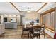 Open floor plan with living area, dining area, and a kitchen featuring an island and modern appliances at 2437 W Wavelyn N Cir, Martinsville, IN 46151