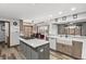 Open kitchen featuring an island cooktop, quartz countertops and stainless steel appliances at 2437 W Wavelyn N Cir, Martinsville, IN 46151