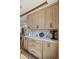 Kitchen with modern wood cabinets, dark hardware, updated appliances, and stylish countertops and backsplash at 2437 W Wavelyn N Cir, Martinsville, IN 46151