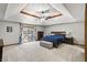 This primary bedroom features an ornate tray ceiling, lots of carpet and large picture windows at 2437 W Wavelyn N Cir, Martinsville, IN 46151