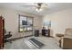 Carpeted home office with a sit stand desk, walking pad, ceiling fan, and bright natural light at 2437 W Wavelyn N Cir, Martinsville, IN 46151
