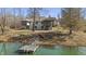 Rear exterior view of a home featuring a dock, lake access, and screened-in porch, perfect for outdoor relaxation at 2437 W Wavelyn N Cir, Martinsville, IN 46151