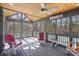 Inviting screened porch with deck ceiling, fan, heaters, and ample seating for enjoying scenic views of the surrounding landscape at 2437 W Wavelyn N Cir, Martinsville, IN 46151
