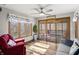 Cozy sun room with views of the lake, comfortable seating, ceiling fan and access to an adjacent screened in porch at 2437 W Wavelyn N Cir, Martinsville, IN 46151