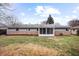 Spacious backyard with lush greenery, a well-maintained lawn, and a charming patio area at 3013 E 7Th St, Anderson, IN 46012