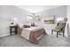 Bright bedroom with gray walls, carpet, and matching nightstands at 3013 E 7Th St, Anderson, IN 46012
