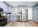 Well-lit kitchen featuring shaker cabinets, stainless steel appliances and sleek countertops at 3013 E 7Th St, Anderson, IN 46012