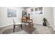 Cozy office space is furnished with a desk, chairs, shelving, and a large window at 3013 E 7Th St, Anderson, IN 46012