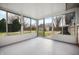 Bright sunroom with large windows offering beautiful views of the backyard and landscaping at 3013 E 7Th St, Anderson, IN 46012