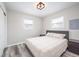 Bright bedroom with two windows and a bed setup to include end tables and modern lighting at 3045 N Lasalle St, Indianapolis, IN 46218
