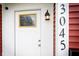 An up-close look at the front door with decorative window and exterior light fixture at 3045 N Lasalle St, Indianapolis, IN 46218