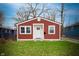 Charming home featuring red siding, a white door, and well-maintained landscaping at 3045 N Lasalle St, Indianapolis, IN 46218