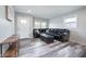 Spacious living room featuring sleek floors and a comfortable black leather sofa at 3045 N Lasalle St, Indianapolis, IN 46218