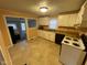 Well-lit kitchen with white cabinets, laminate countertops, and modern appliances including an oven and microwave at 318 Tague St, Greenfield, IN 46140